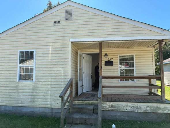 Clean white siding on a single-story home after washing